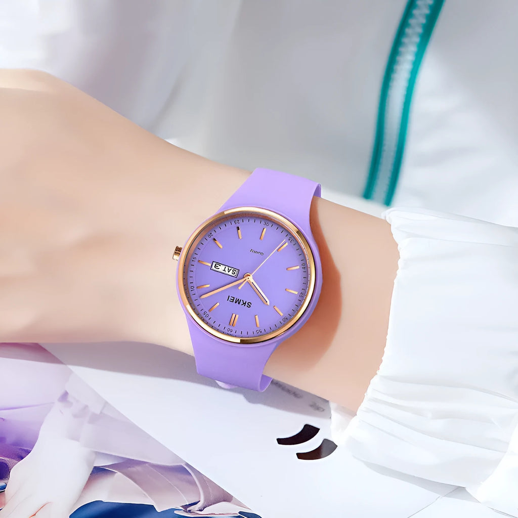 Women's silicone strap quartz watch with 42mm dial and calendar on a wrist, showing light blue colour option.