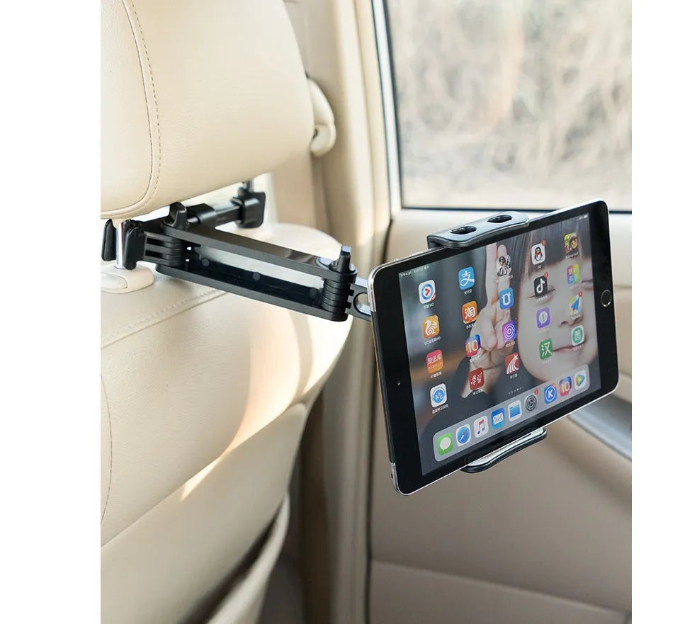 Black universal car phone holder mounted on rear seat base with tablet secured in clamp