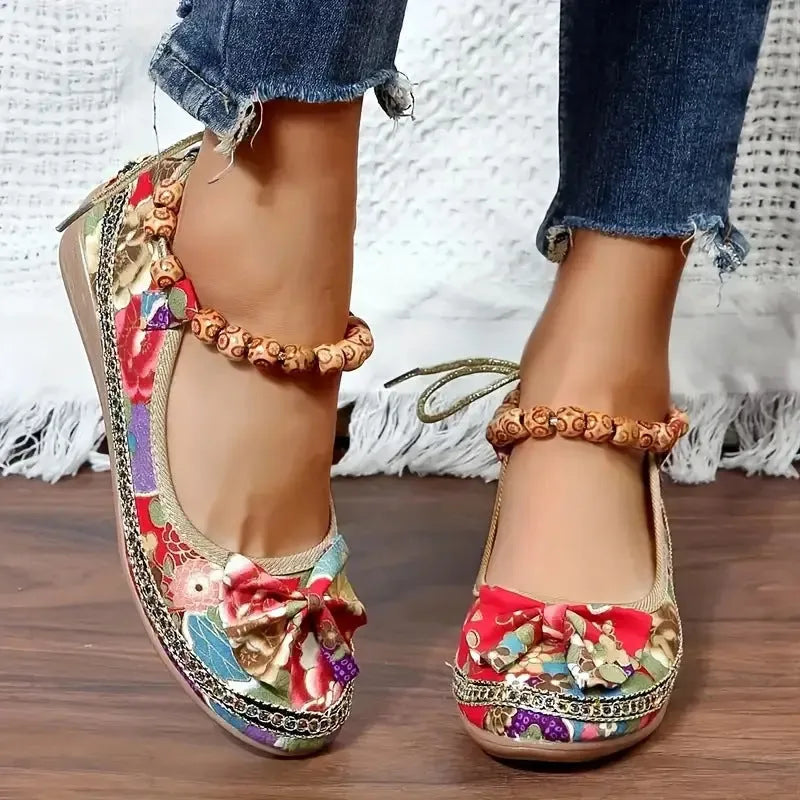 Women's black ethnic style platform sandals with elastic band and round toe on a cloth upper.