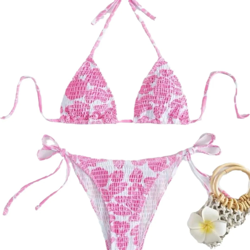 Women's floral print halter swimsuit briefs in light blue on a mannequin.