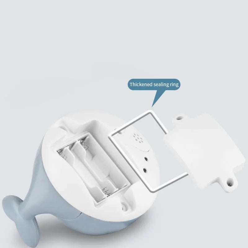 Electric whale-shaped bath spray toy with water-activated automatic spray, LED lights, and floating capability