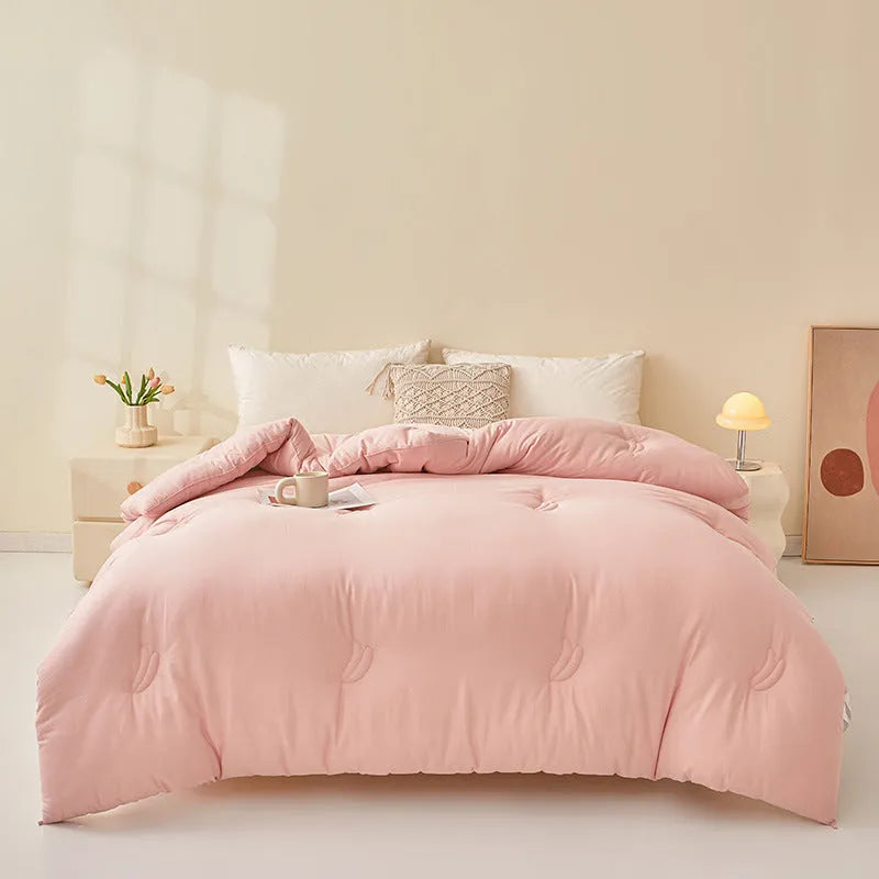 Soybean fibre quilt with pure cotton twill cover in grey, shown on a bed.