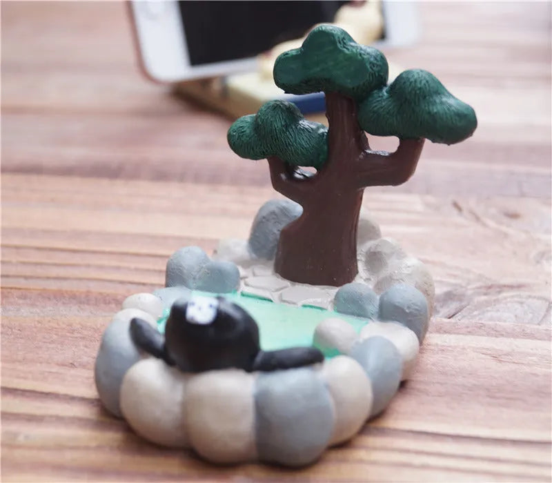 Hand-painted resin cat mobile phone holder in black cat TV design with slot for phone