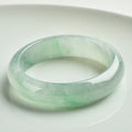Light green jade bracelet showing natural stone material on wrist