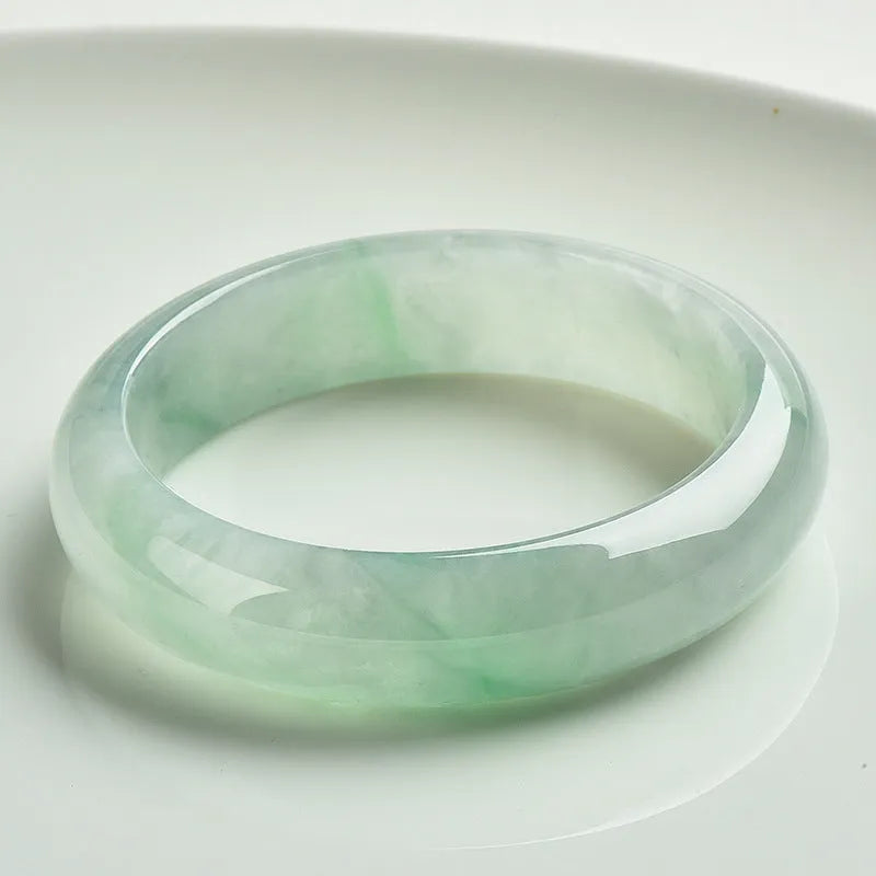 Light green jade bracelet showing natural stone material on wrist