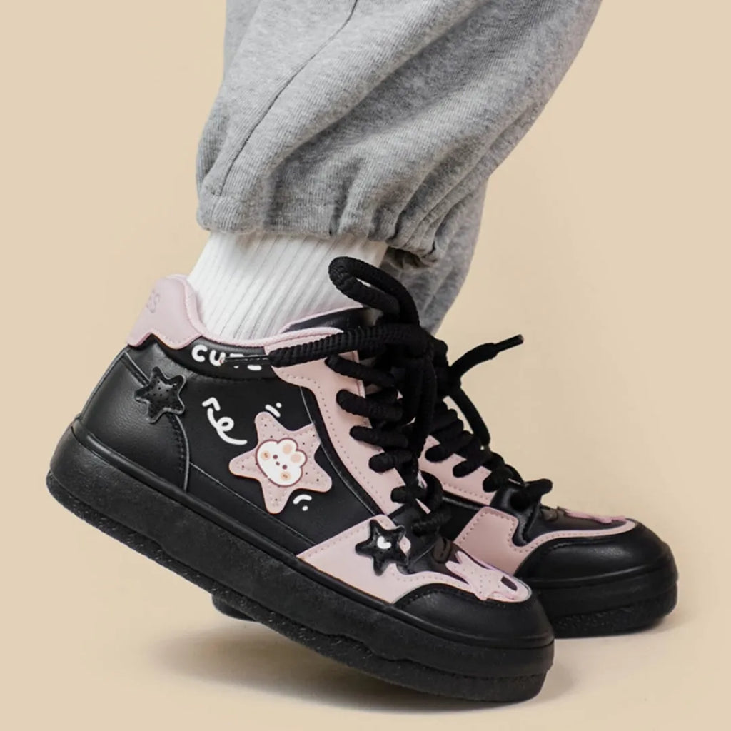 Women's black high top sneakers with cartoon anime pattern, colour blocking, cross straps, and lace-up closure