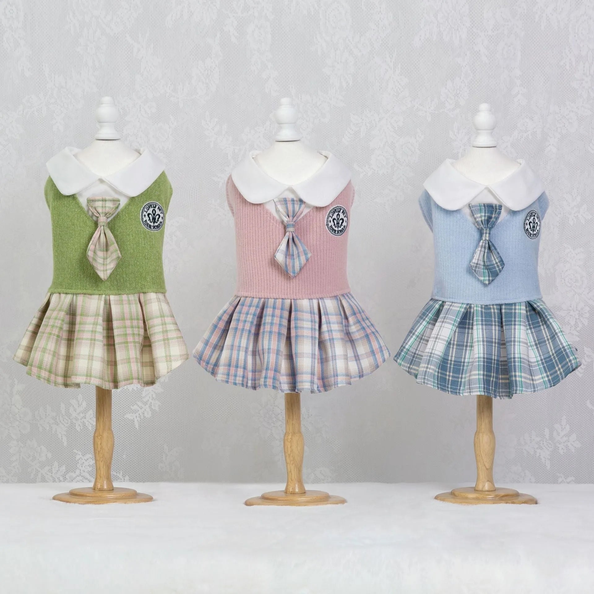 A pink tartan princess-style skirt for small dogs or cats, shown alongside blue and green colour options.