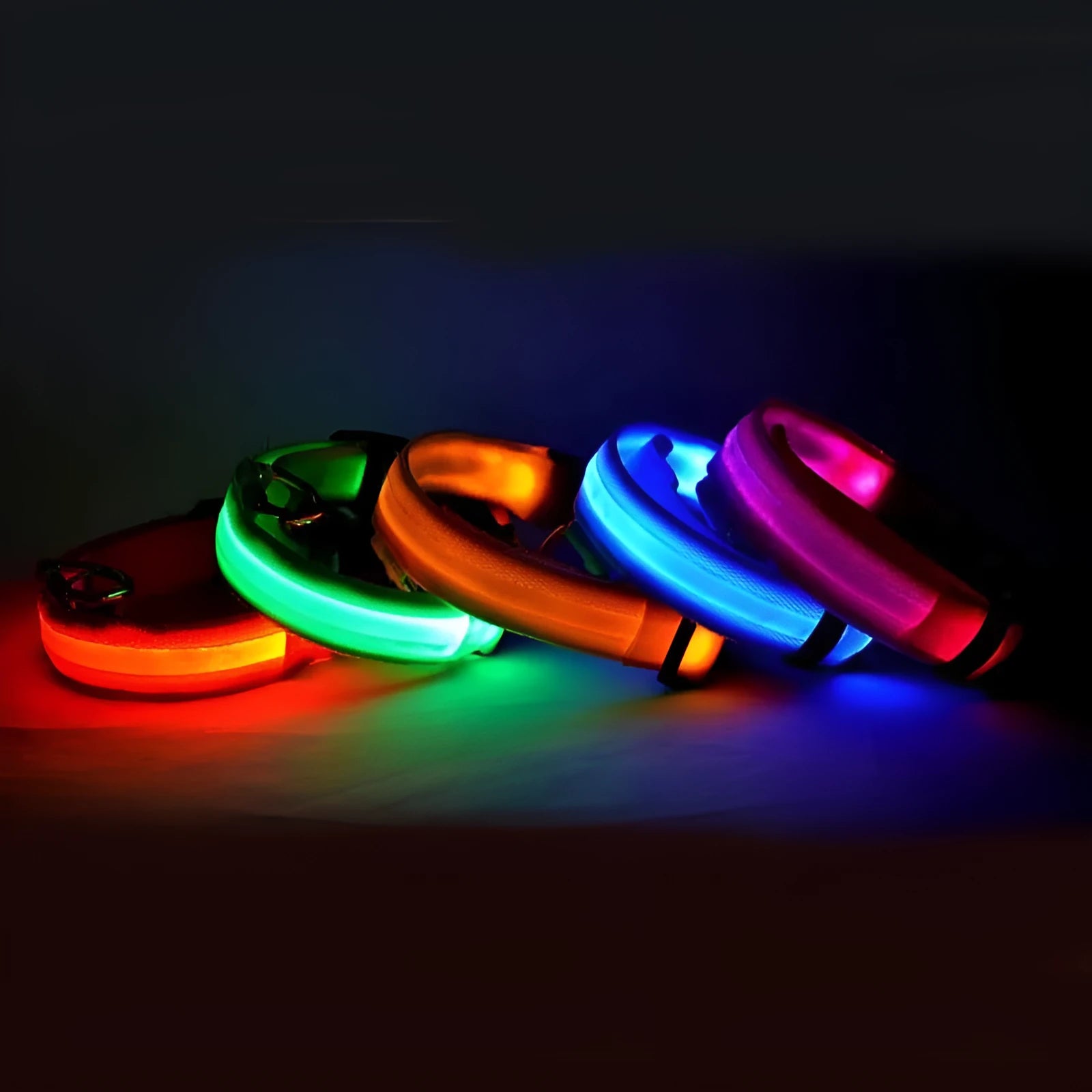 Nylon LED dog collar glowing blue on a black background, with adjustable buckle and four light modes for pet night safety