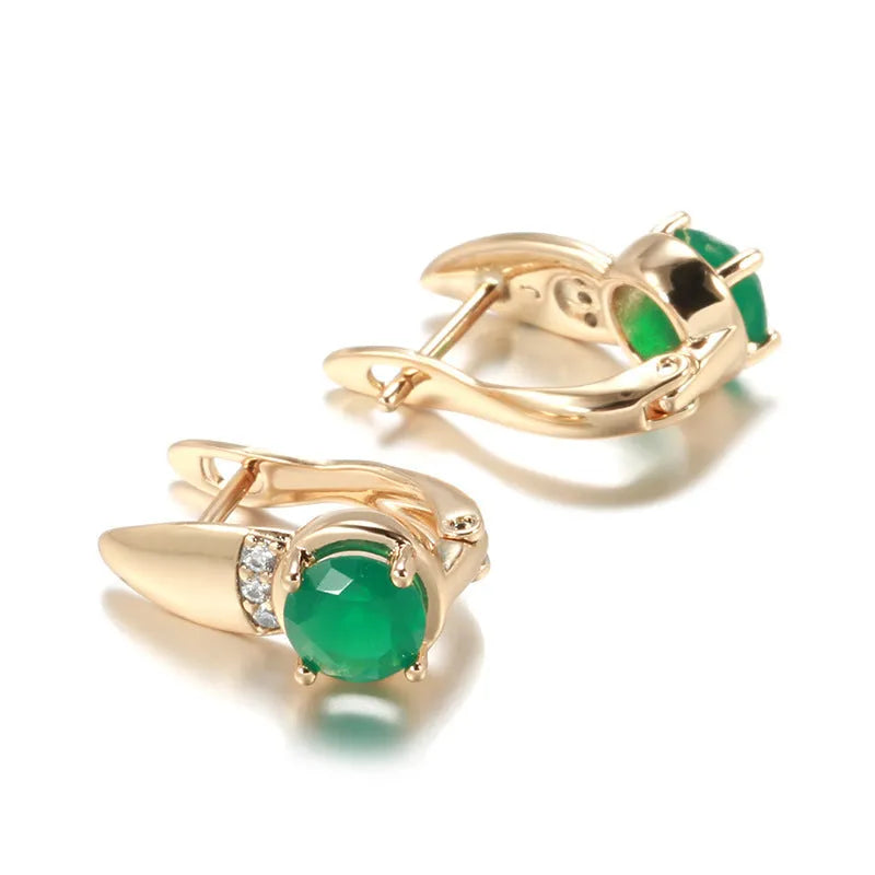 Rose gold plated copper stud earrings with emerald green zircon stone in U-shaped retro design on white background