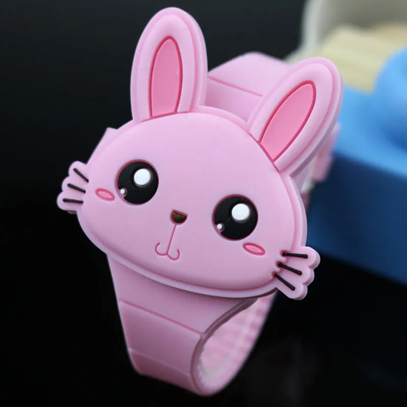 Children's electronic watch with 55mm plastic cartoon dial, silicone strap, and stainless steel pin buckle on a child's wrist