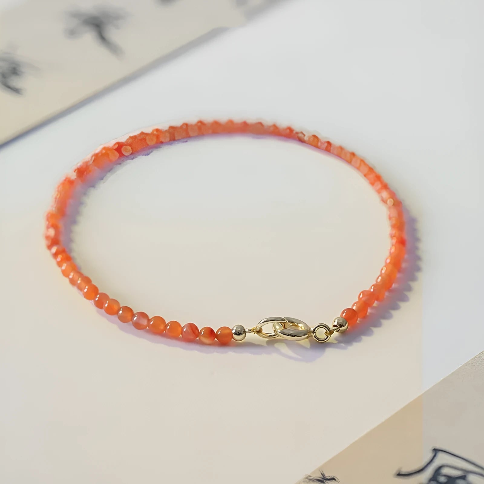 Women's retro bracelet with natural southern red agate beads in cherry red and persimmon red on a white background.