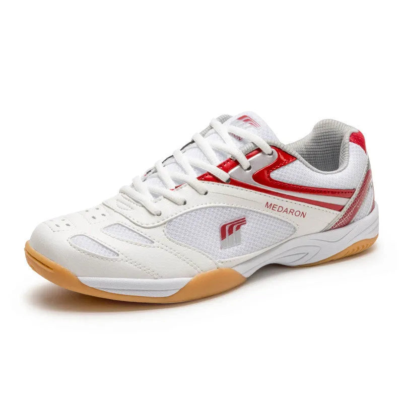 Table tennis sneakers in white and red colour with mesh upper, natural rubber outsole and front lace-up closure