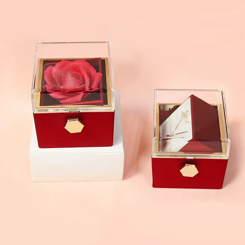 Rotating jewellery gift box with a preserved red rose under a clear acrylic dome.