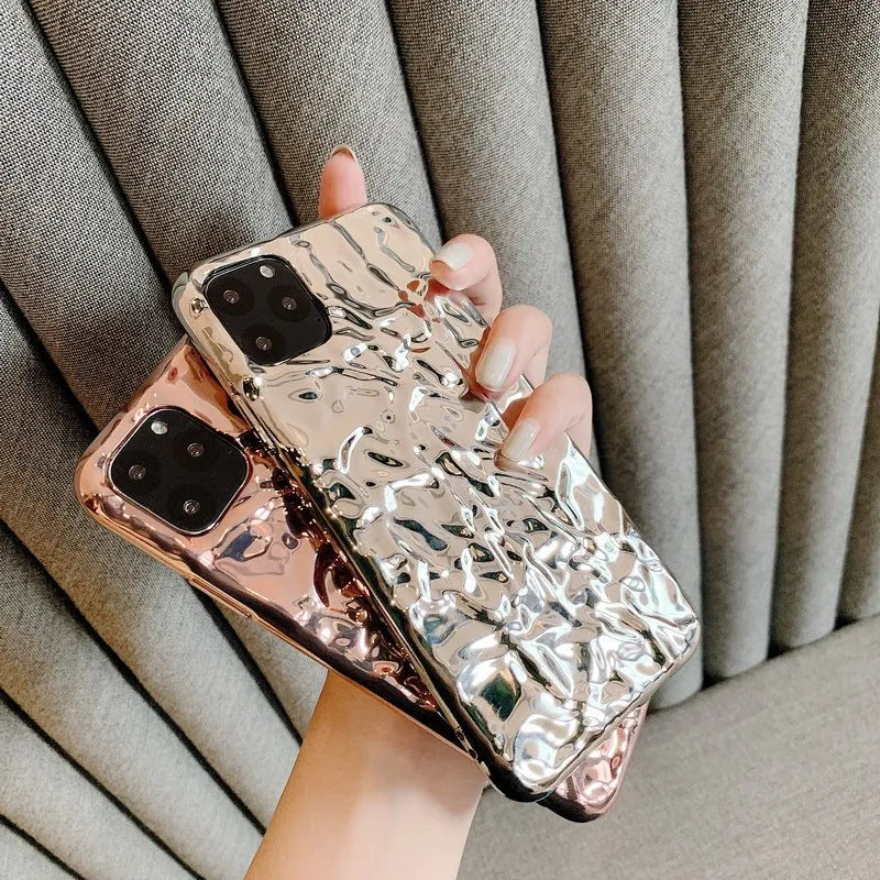 Electroplated rose gold TPU folded back case for iPhone on a table.