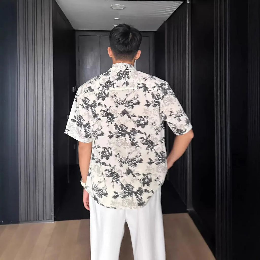 Loose-fitting white women's short sleeve shirt with a floral print pattern.