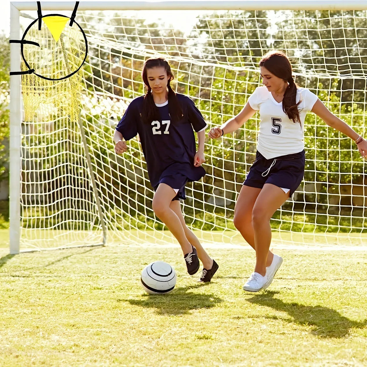 Black portable soccer training goal net with fibreglass poles set up on grass for practice.
