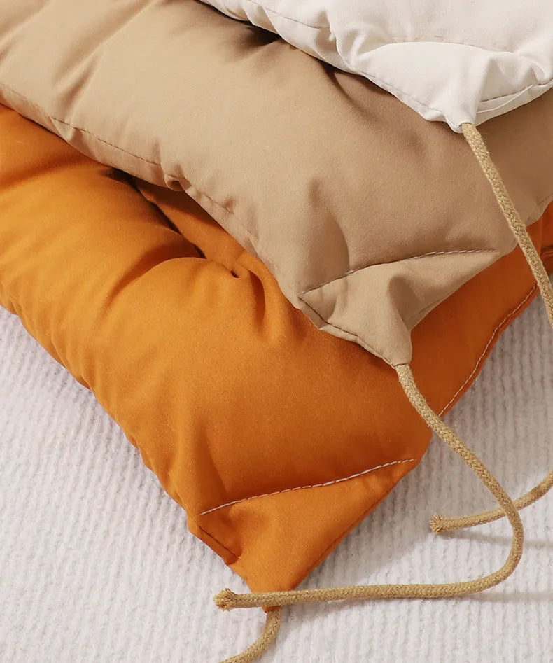 Beige tied cage cushion for small dog in crate showing secure attachment and warm bedding platform.
