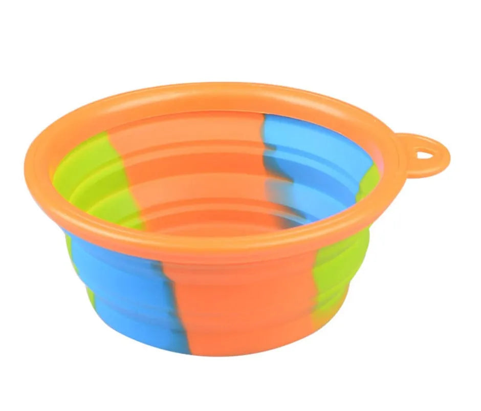 Collapsible silicone dog bowl in camouflage pattern folded flat on green surface