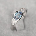 Geometric ellipse ring with zircon inlay in white gold colour, showing contemporary jewellery design