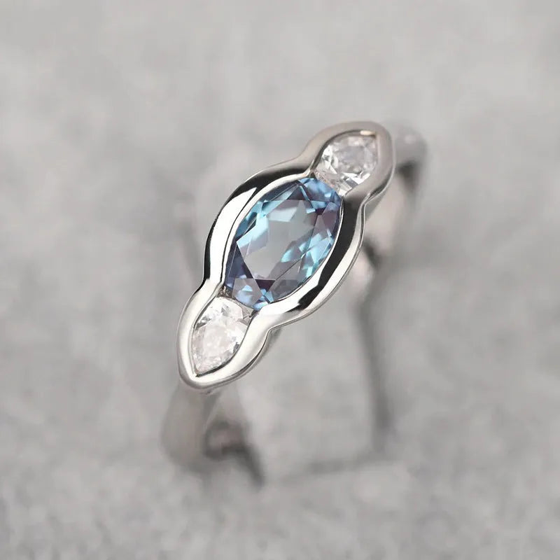 Geometric ellipse ring with zircon inlay in white gold colour, showing contemporary jewellery design