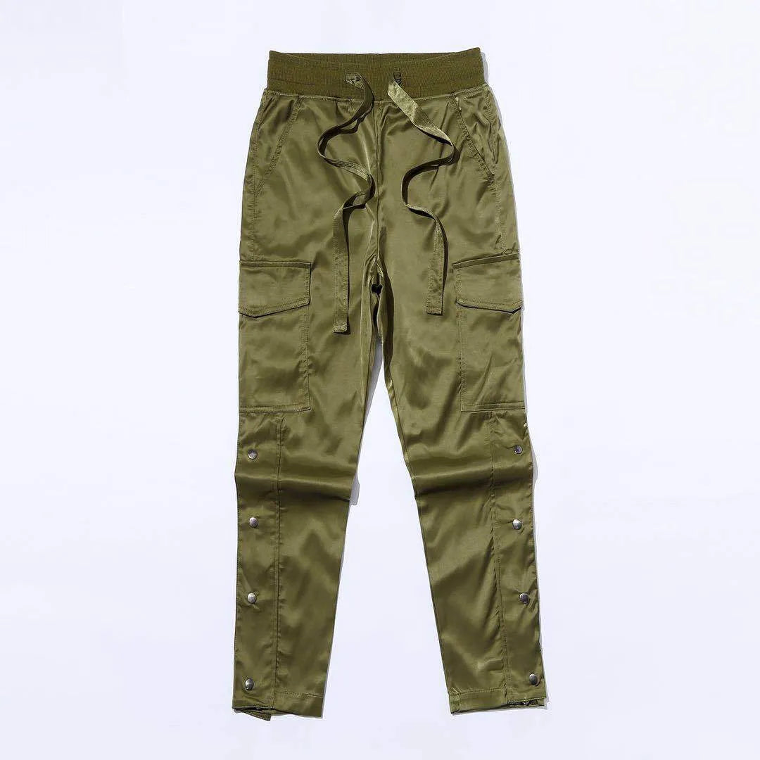 Men's cotton cargo pants with green colour, straight leg, and Velcro button closure on black background