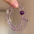 Women's artificial amethyst bracelet with four-leaf clover pendant and pearl accents on a U-shaped cuff.