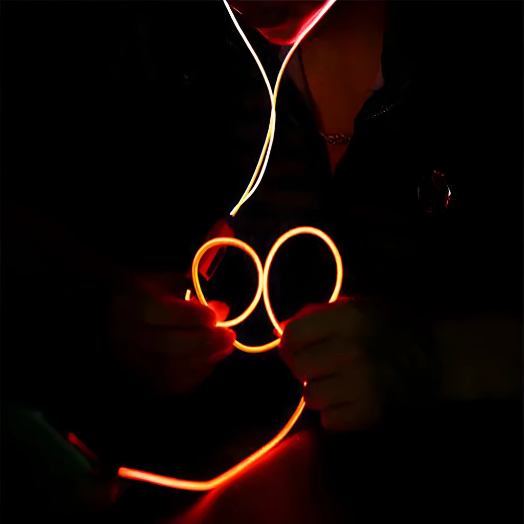 Blue Magic Light LED earphones with glowing cable connected to a phone showing rhythm-sync light effects.