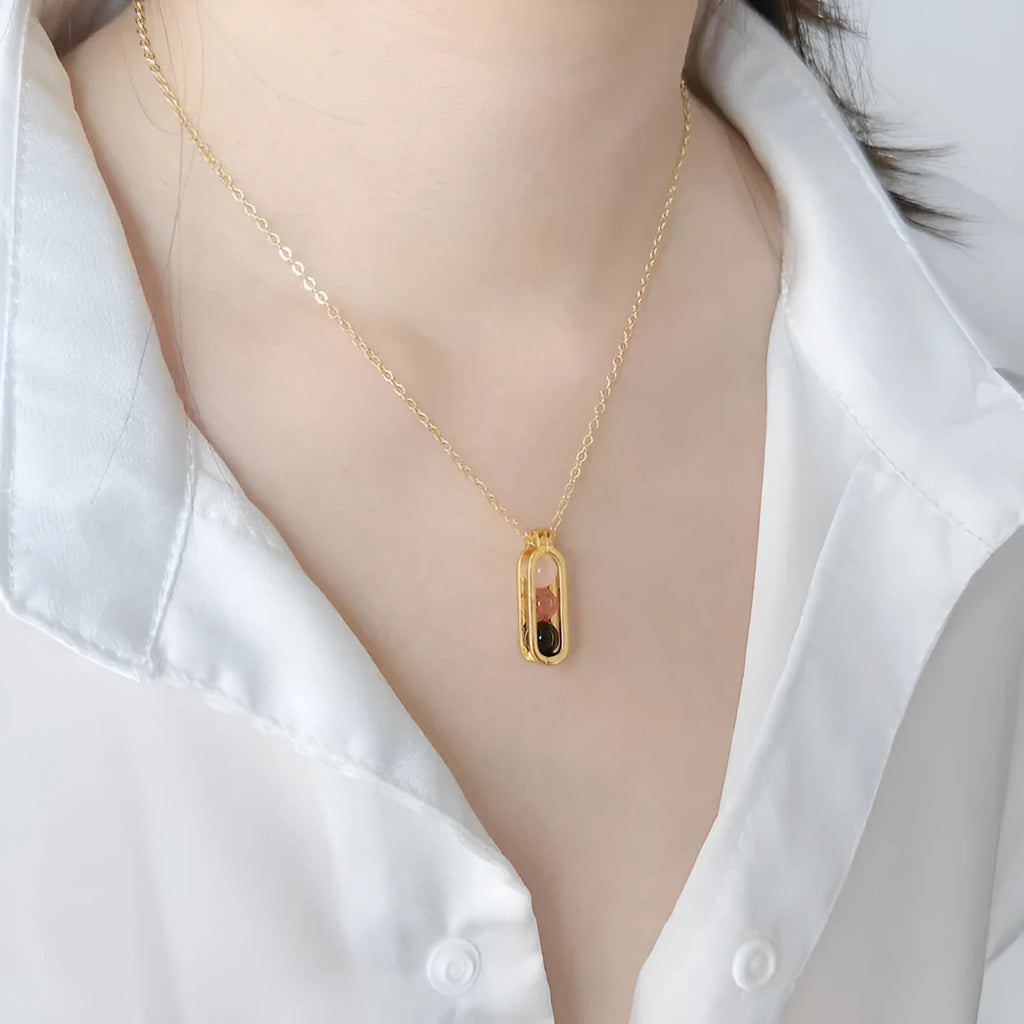 Minority simple pearl necklace with gold titanium steel chain and inlaid pearl pendant on plain background