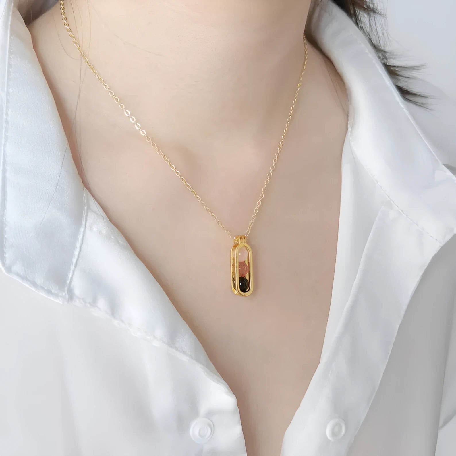 Minority simple pearl necklace with gold titanium steel chain and inlaid pearl pendant on plain background
