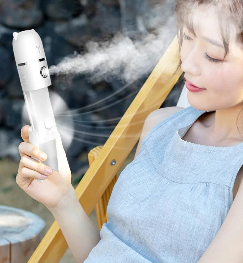 White USB rechargeable handheld spray fan with water tank, flashlight, and power bank function