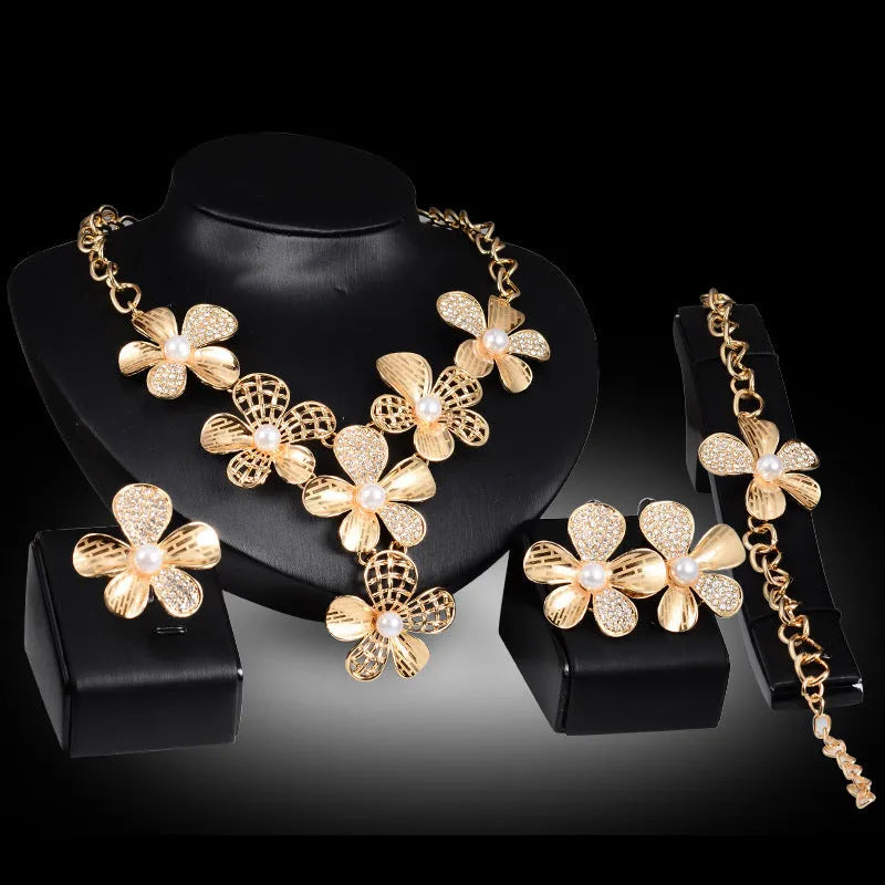 Gold alloy four-piece jewelry set with necklace, earrings, and bracelet in 18K gold finish, artificial gem details