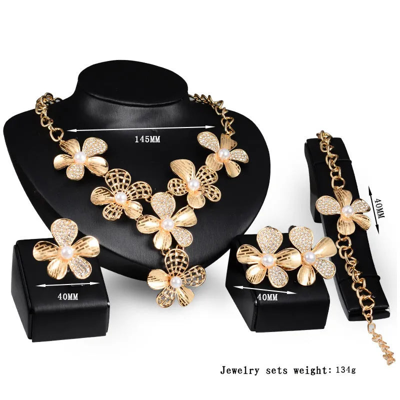 Gold alloy four-piece jewelry set with necklace, earrings, and bracelet in 18K gold finish, artificial gem details