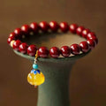 Gold cinnabar bracelet with wave design featuring copper bead accents in national style