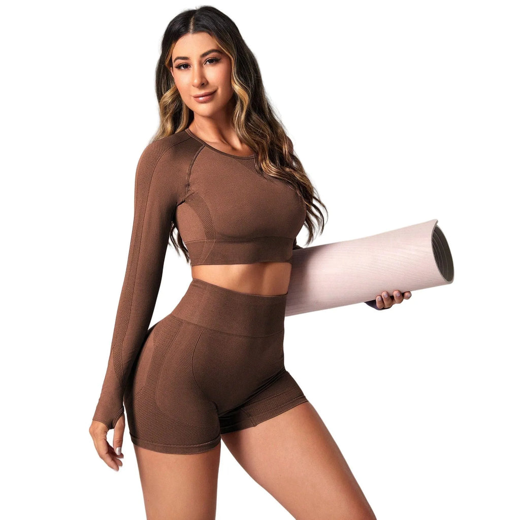 Women's high-waisted yoga suit set in black, featuring a long-sleeved top and tight leggings.