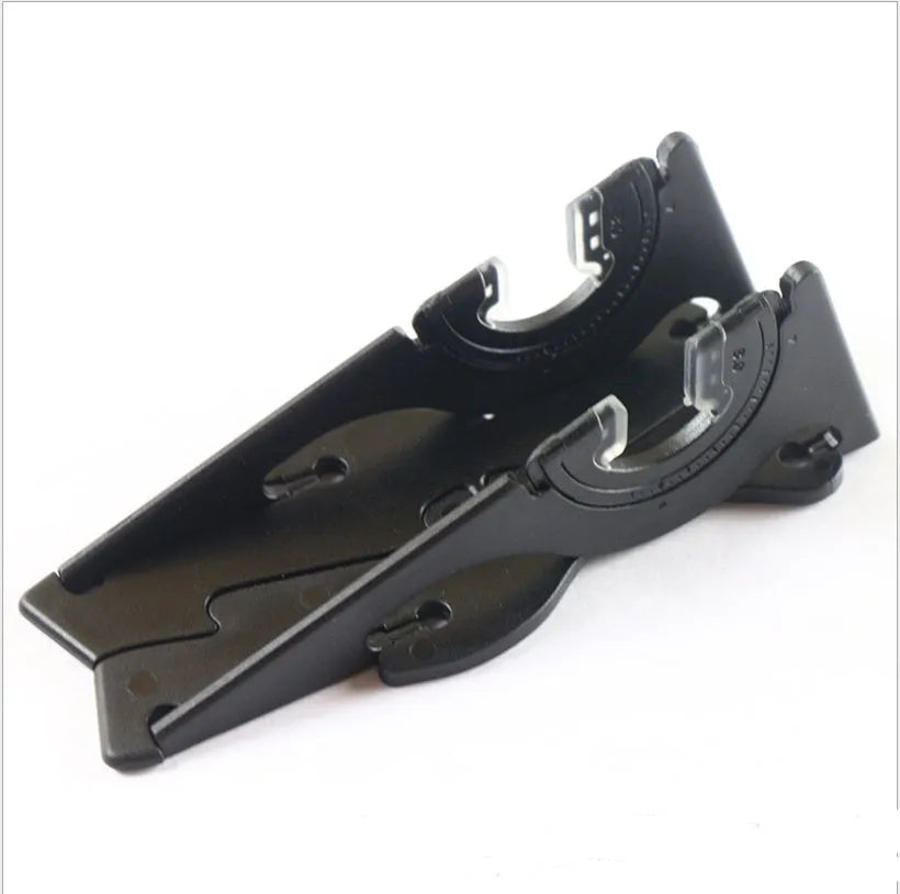 Black card-type plastic mobile phone holder on a desk, holding a smartphone upright.