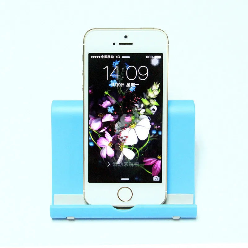 Anti-slip foldable phone holder with silicone pad in black, unfolded on a desk