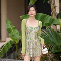 Women's pink floral one-piece jumpsuit swimsuit with suspender straps on hanger