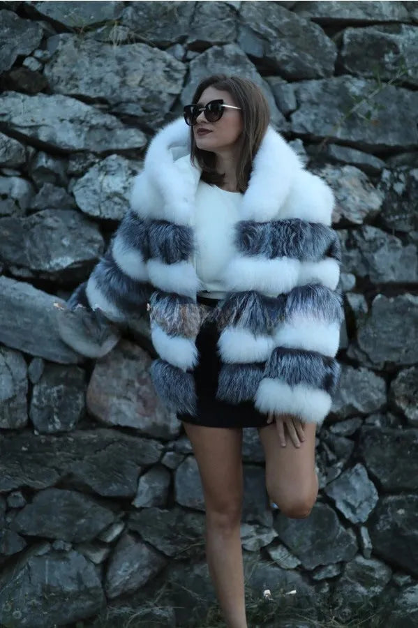 Women's loose fit artificial fur hooded coat in white silver fox colour on a hanger.
