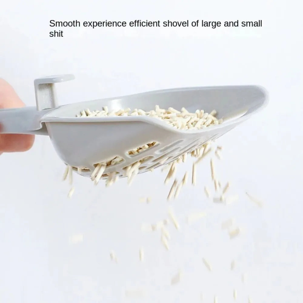 Grey plastic cat litter scoop with detachable base stand showing drainage slots