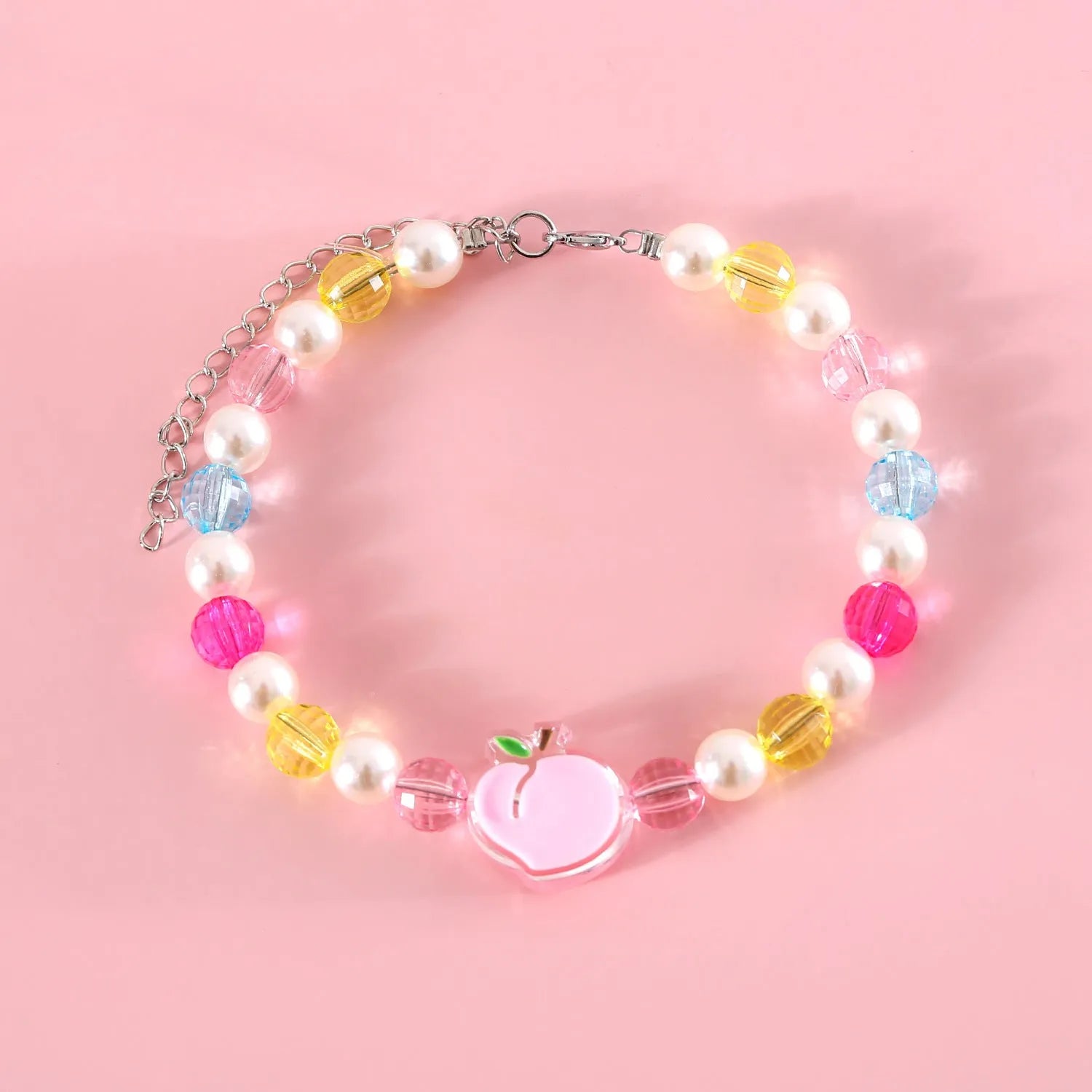 Colourful plastic pearl necklace for small pets on a white background, showing peach, rainbow, and small flower bead design options.