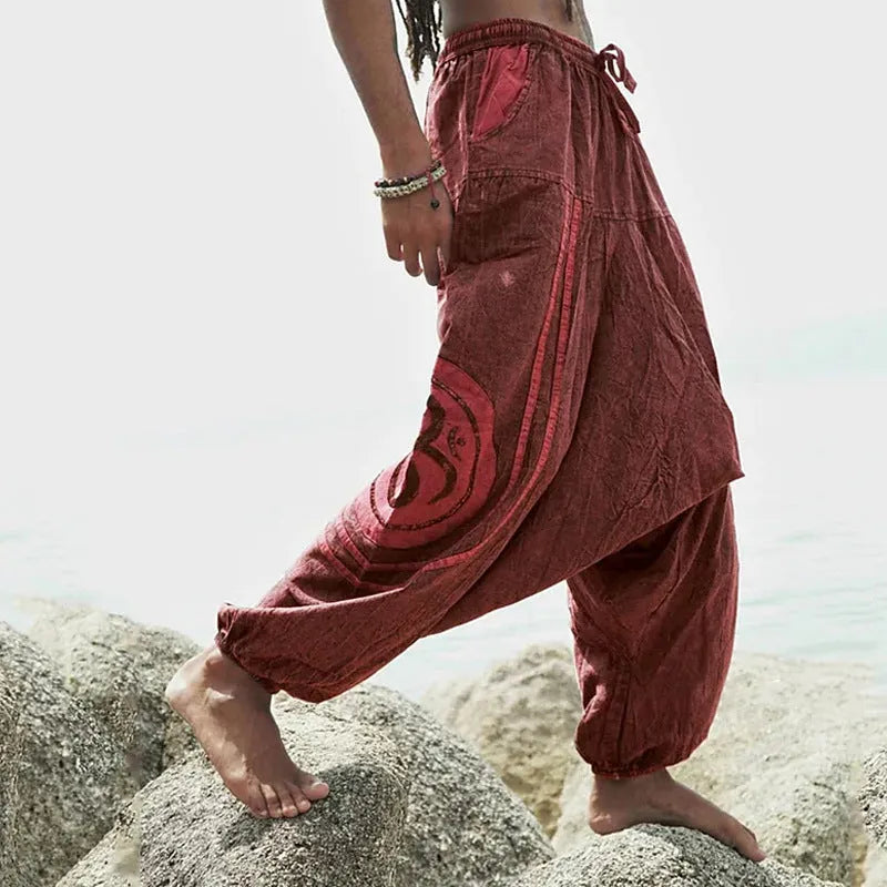 Men's dark green ethnic pattern casual ankle-tied trousers on model, polyester fabric