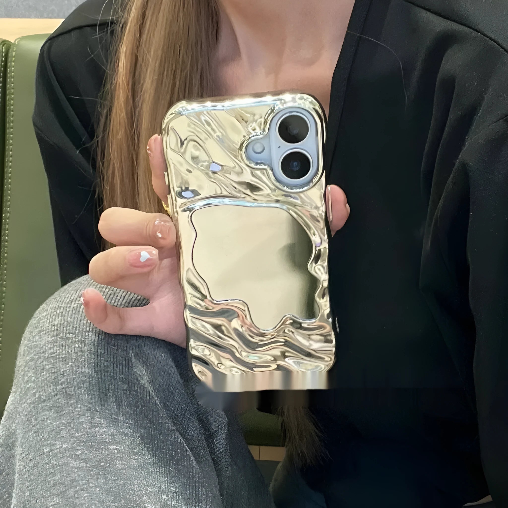 Water ripple texture solid colour mirror phone case for iPhone on a table.