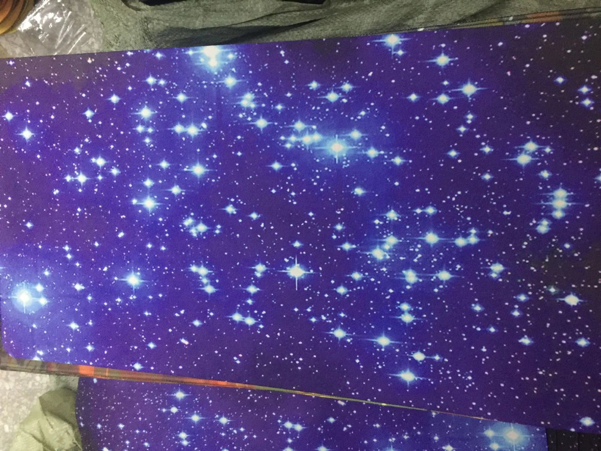 Blue star mouse pad with high-density fabric surface and anti-skid rubber base on a desk