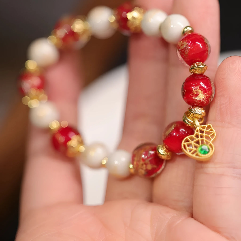 Gold foil coloured glaze ethnic bracelet with geometric Xingshi patterns and hanging gourd charms