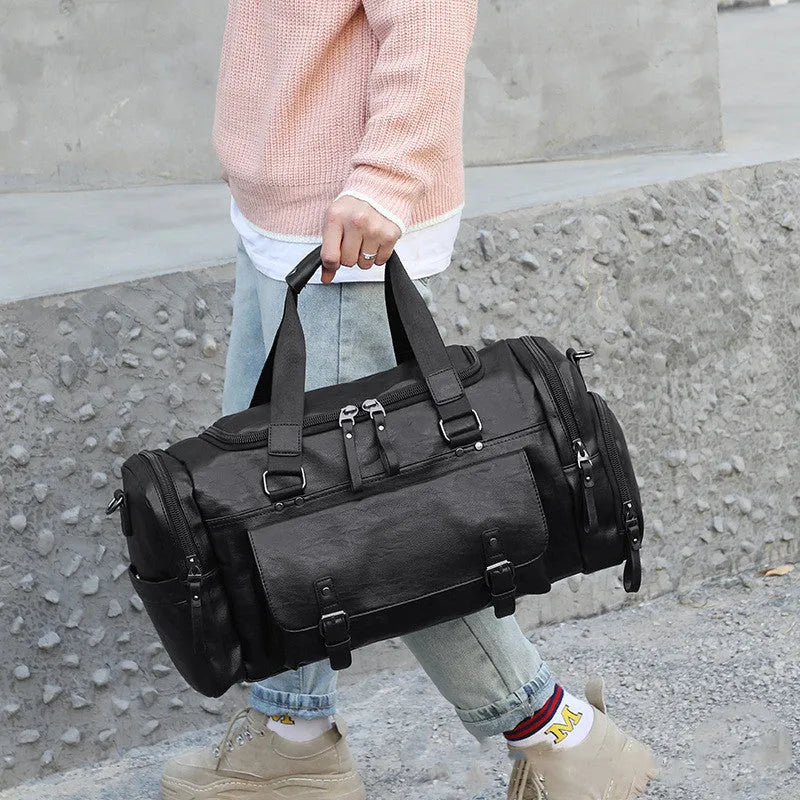 Large black PU travel bag with a dedicated shoe compartment, shown with dimensions of 52cm by 19cm by 27cm.