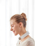 White electric acupressure massager with control buttons on a grey background.