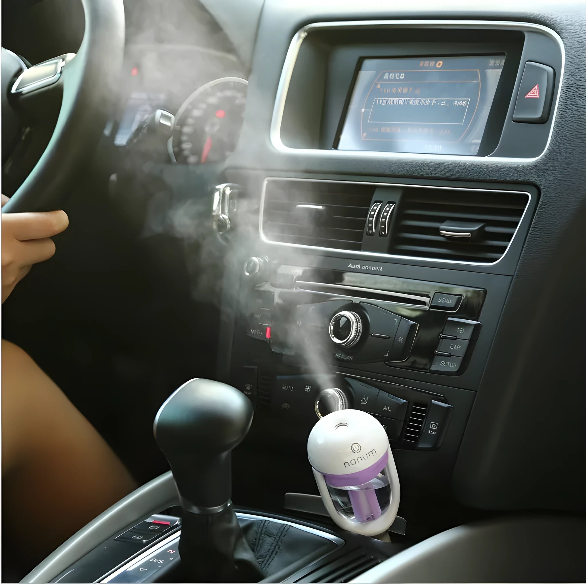 Blue portable car humidifier with rotating nozzle on a car dashboard