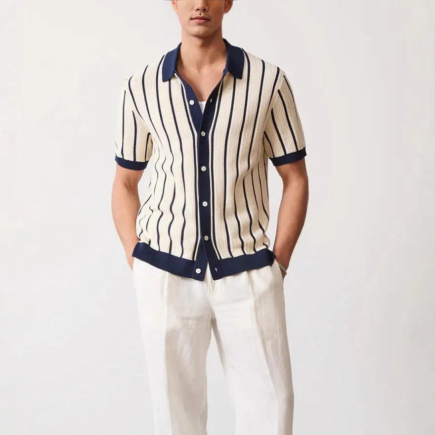 White men's lapel knitted short sleeve shirt with asymmetric stripe design on a hanger.