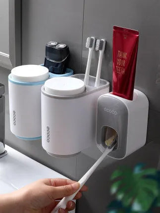 Wall mounted automatic toothpaste dispenser with toothbrush holder and mouthwash cup in black plastic