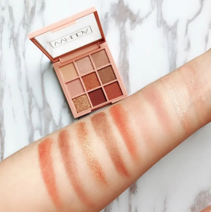 Nine-colour eyeshadow palette with warm brown, charred orange, and nude matte and pearlescent shades